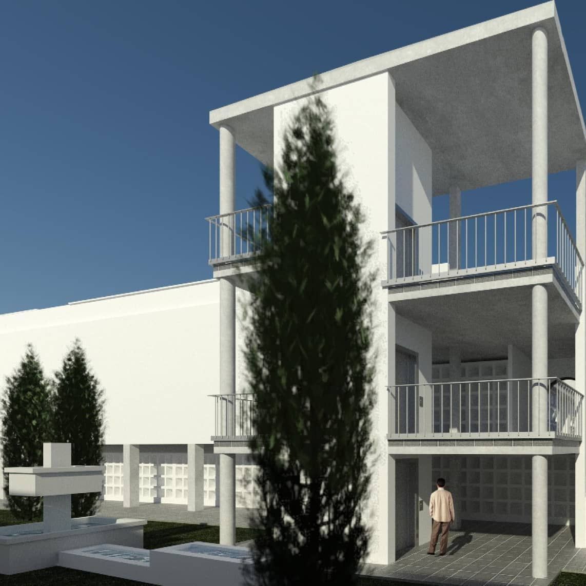 Edificio blanco moderno con balcones, un árbol alto y una persona de pie bajo el porche.