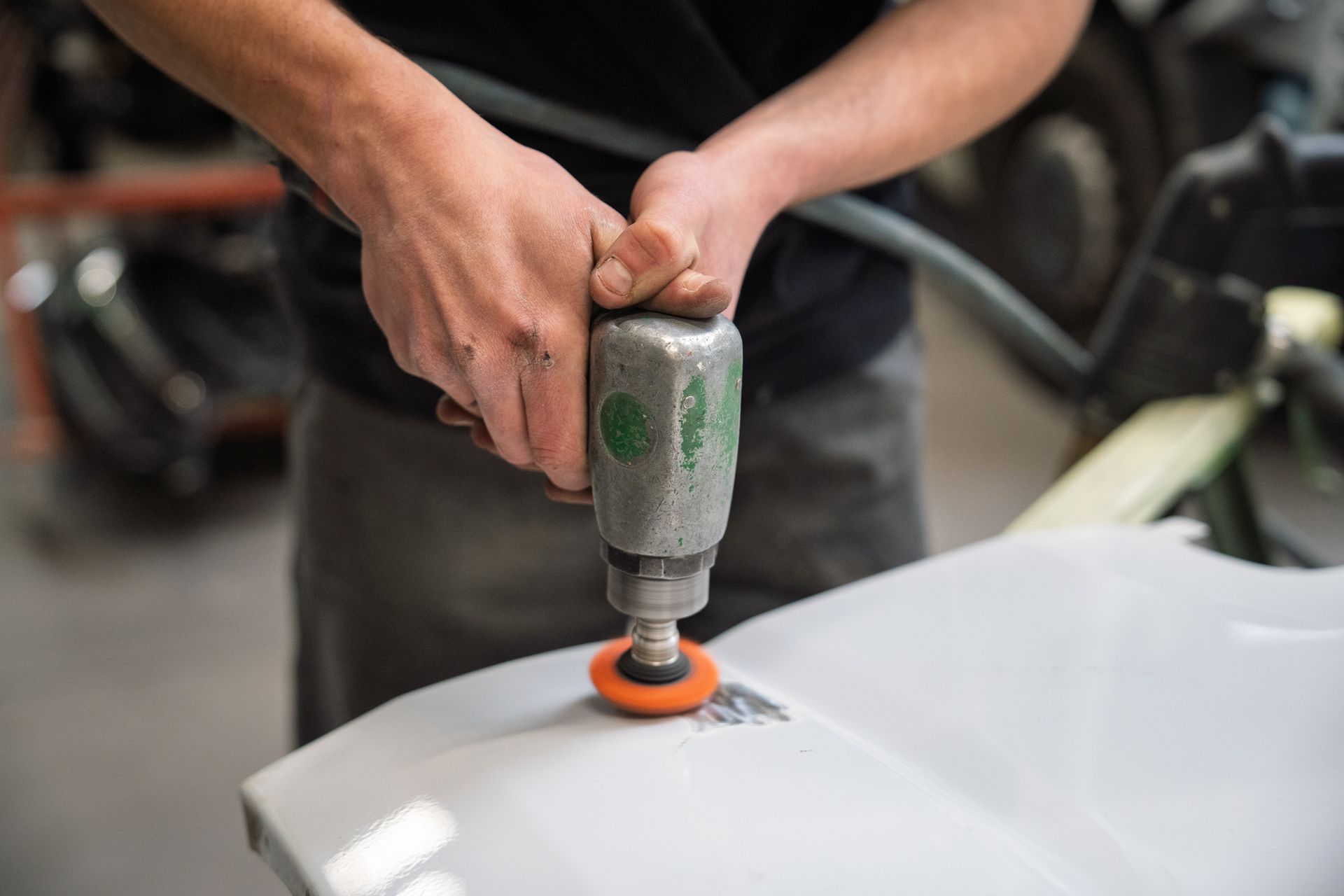 Mains utilisant un pistolet de redressage de carrosserie