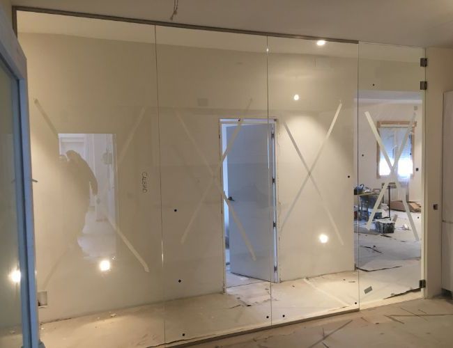 Una habitación con muchas paredes y puertas de cristal.