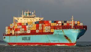 Un gran barco portacontenedores flota sobre un cuerpo de agua.
