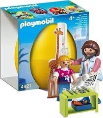 Caja de un set de juguetes Playmobil que muestra a un médico con una jirafa y un bebé en una escena de clínica.
