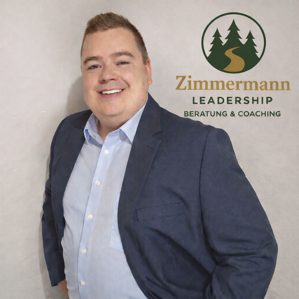 Man in blazer smiles; logo 