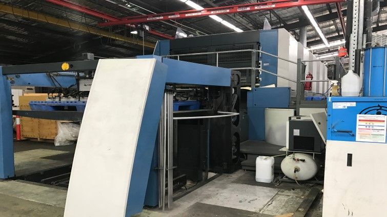 Una máquina azul y blanca está en un almacén.