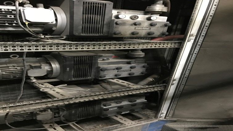 Un montón de equipos eléctricos se encuentran dentro de un gabinete de acero inoxidable.