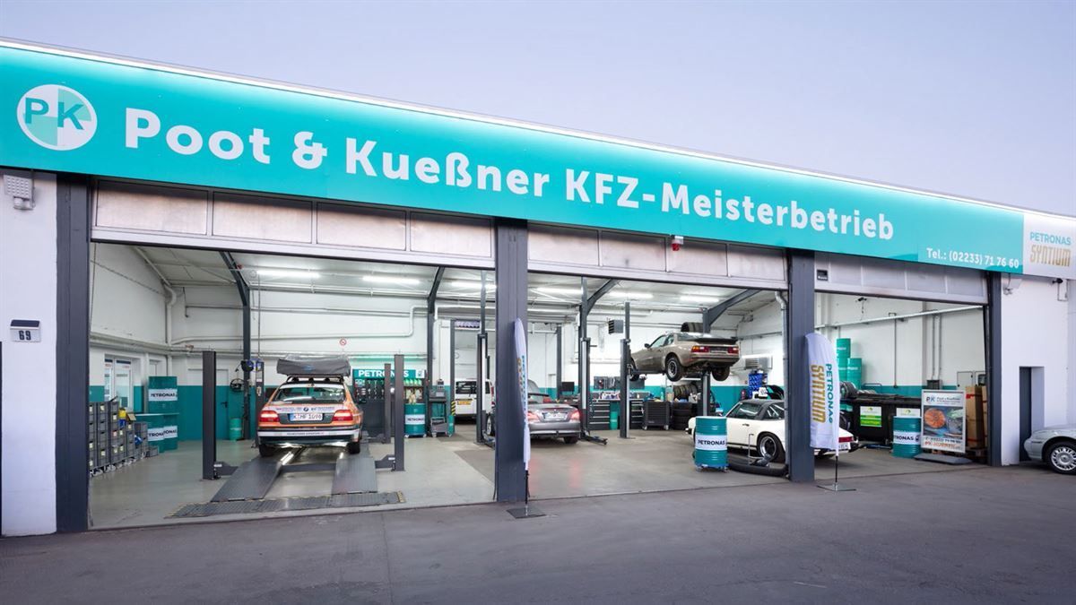 A poot & kuebner kfz-meisterbetrieb garage with cars on lifts