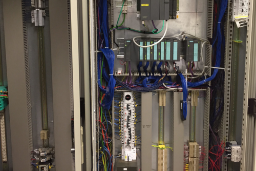 Une grande boîte électrique avec beaucoup de fils qui en sortent.