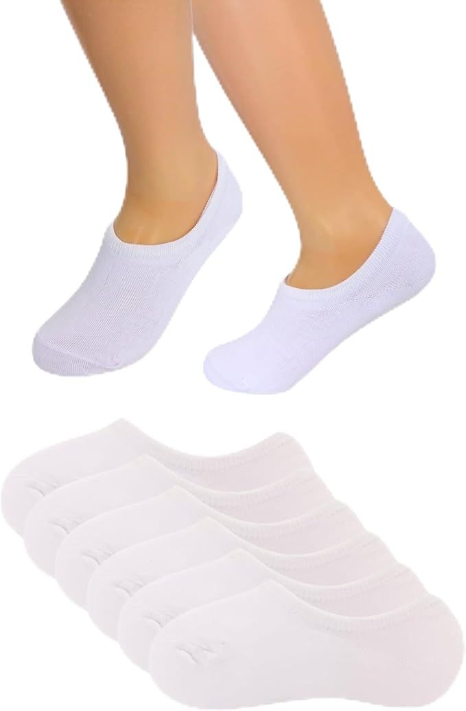 Calcetines blancos invisibles en los pies de una persona y una pila de calcetines similares.