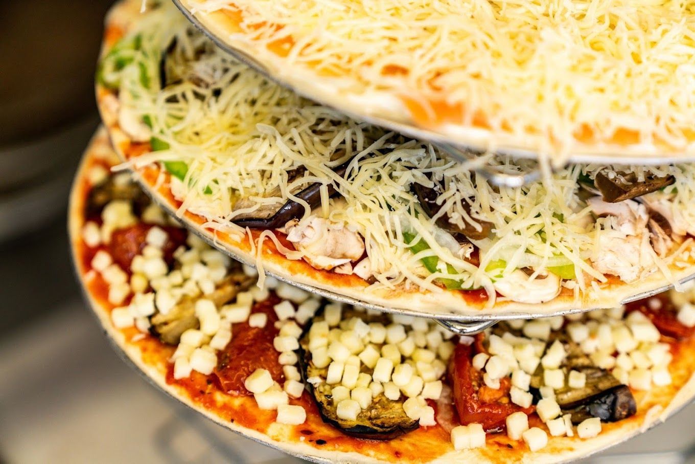 Photo de trois pizzas superposées