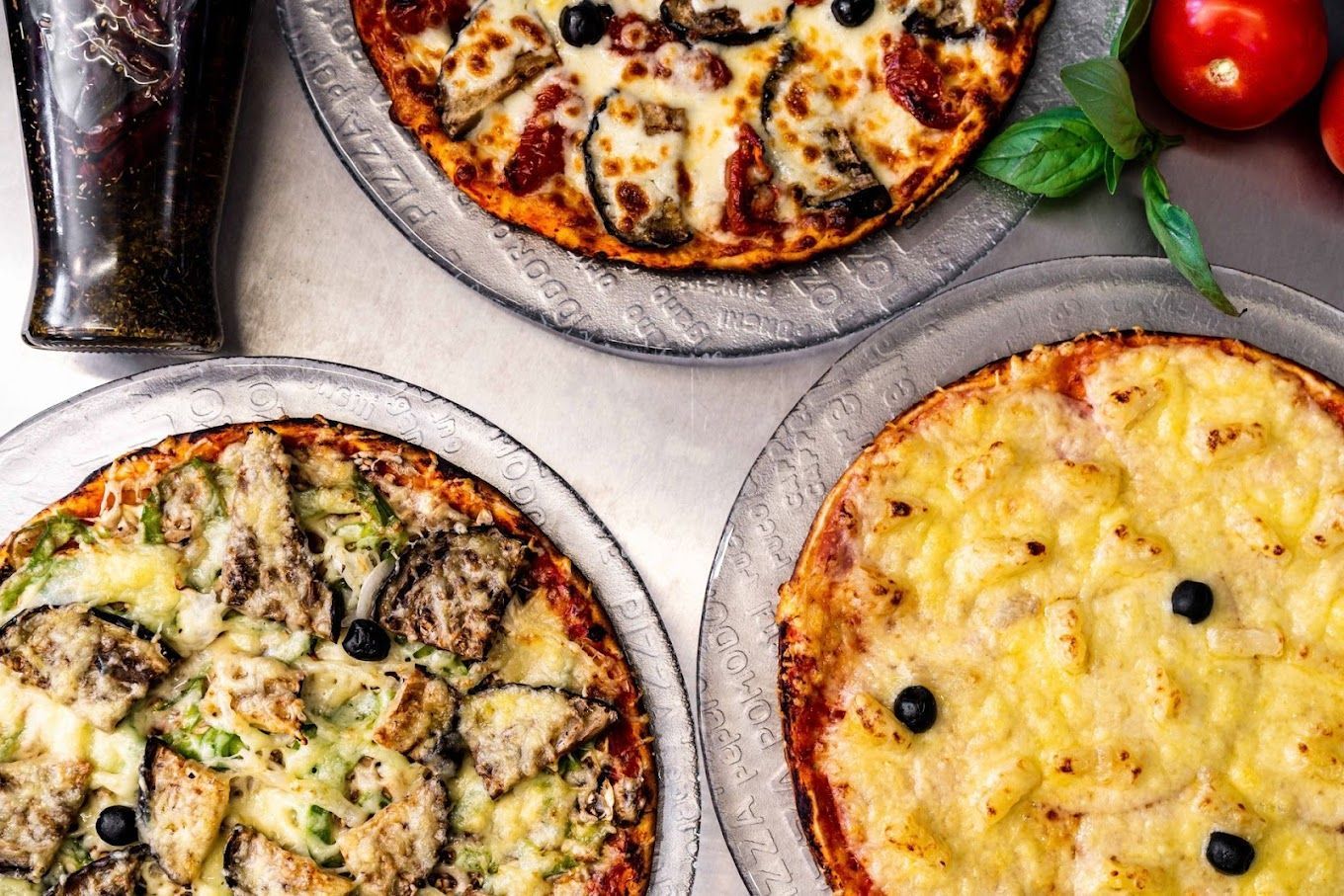 Photo de trois pizzas romaines : une placée en haut et les deux autres alignées en bas