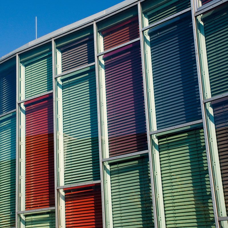 Ein Gebäude mit vielen Fenstern und Jalousien