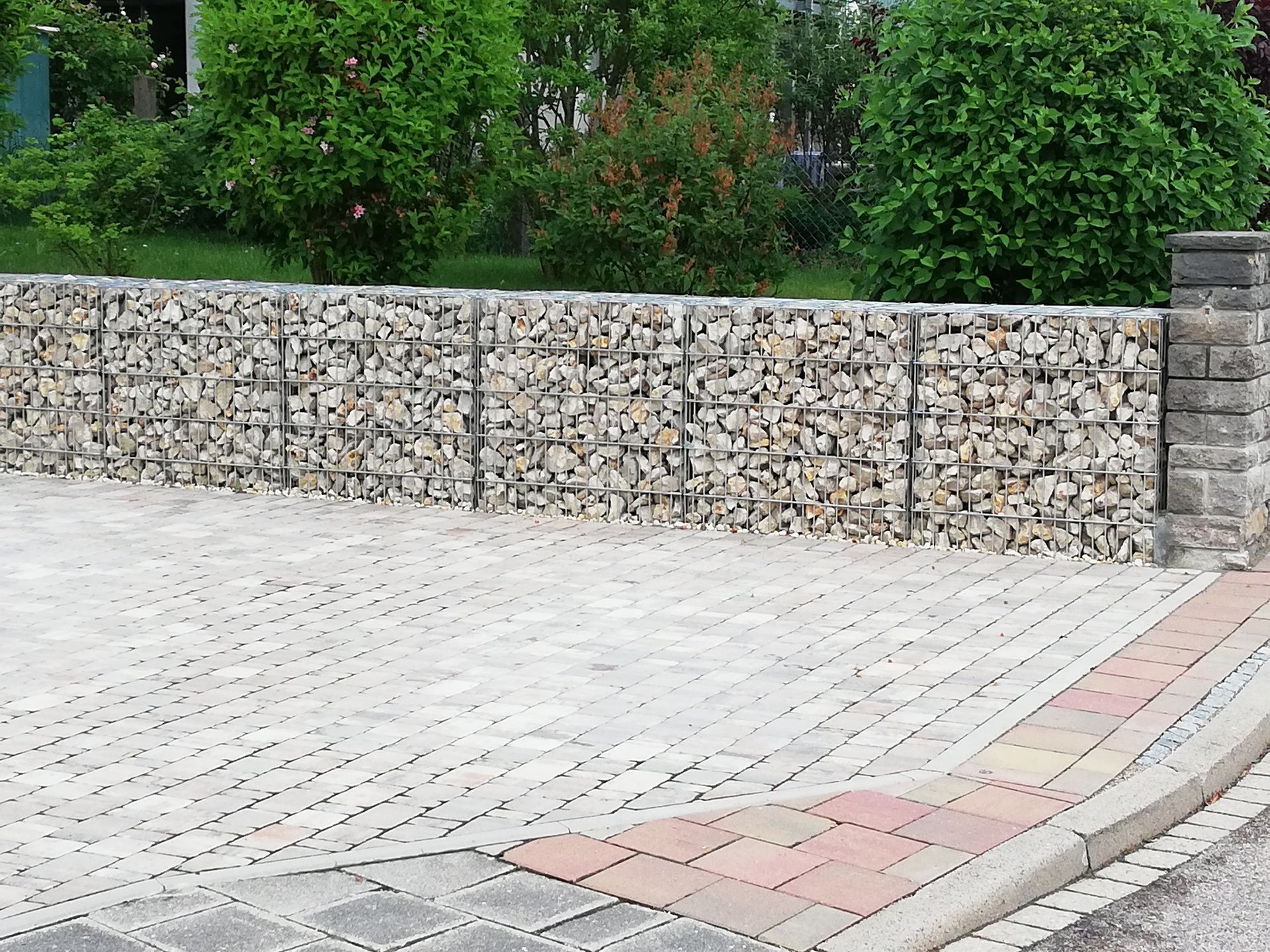 gepflasterte Auffahrt mit einer Mauer aus Steinen