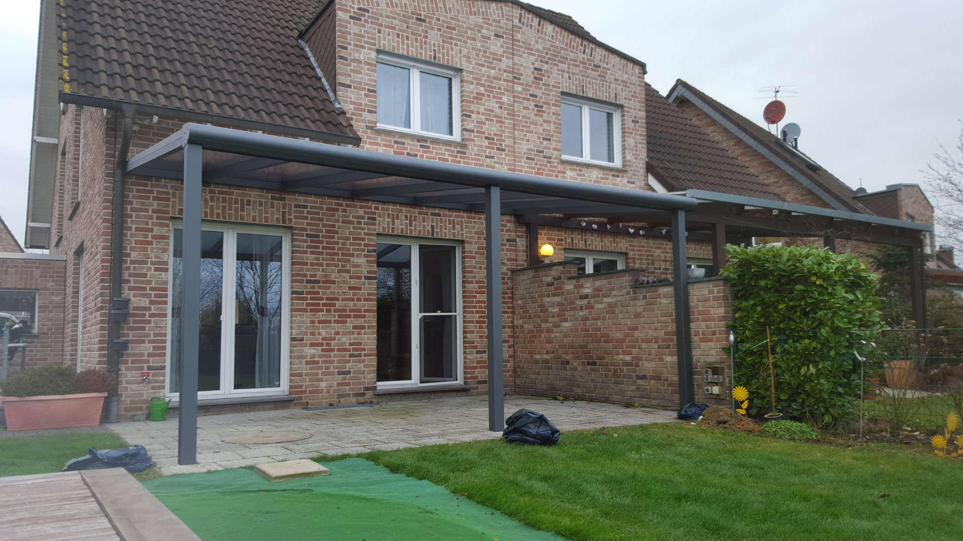 ein Backsteinhaus mit einer überdachten Veranda davor