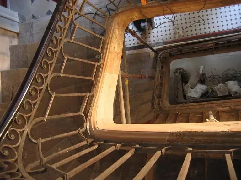 Trois employés analysant une poutre de bois