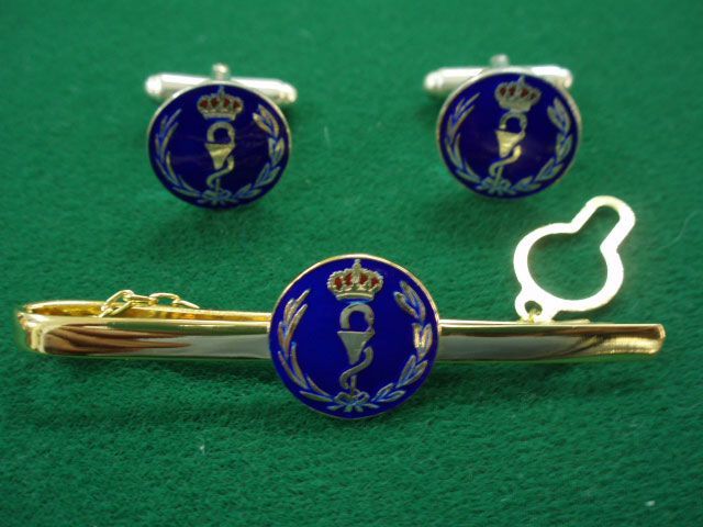 Un par de gemelos y un clip de corbata con un símbolo médico en ellos.