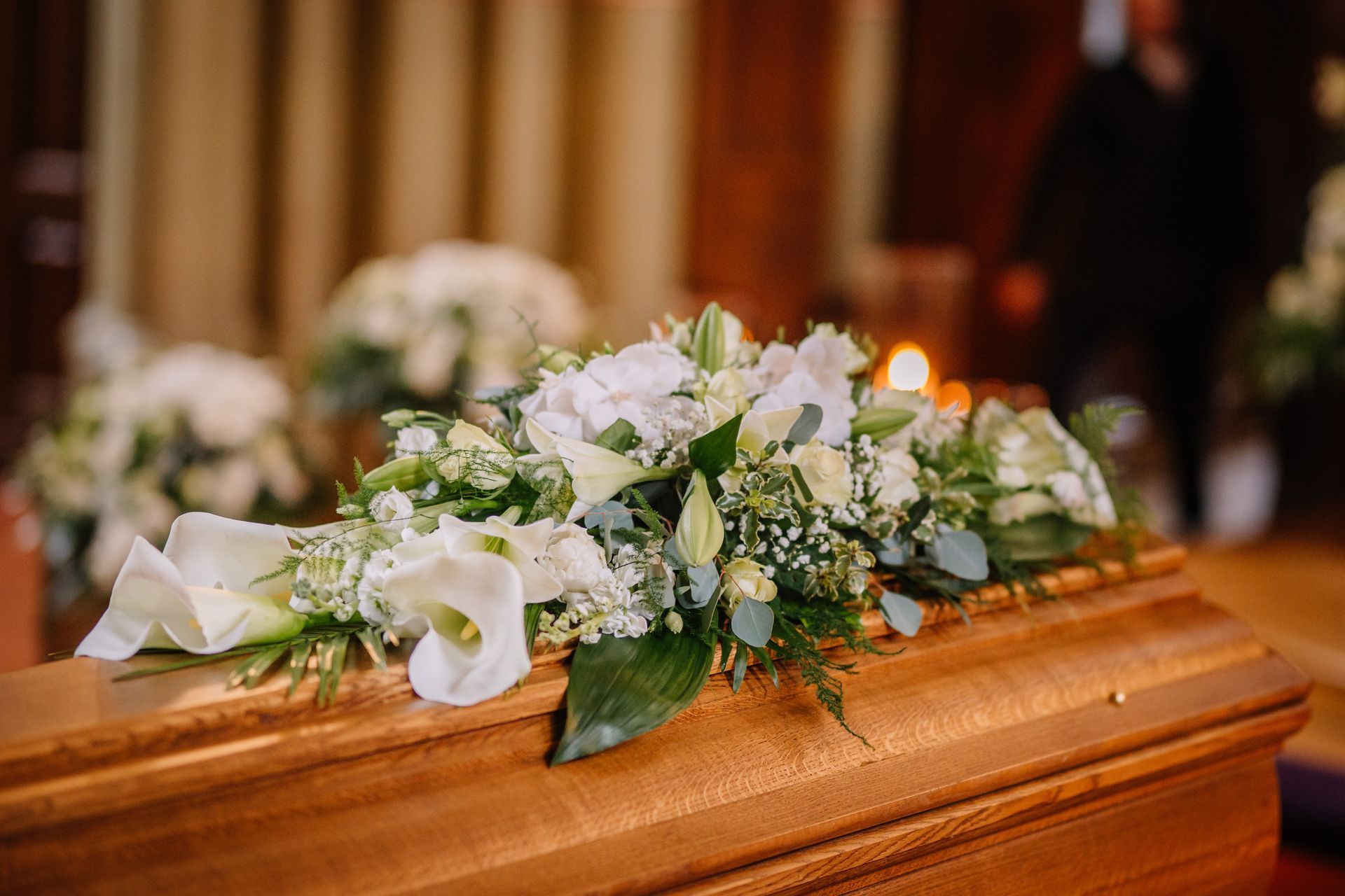 Des fleurs blanches posées sur un cercueil.