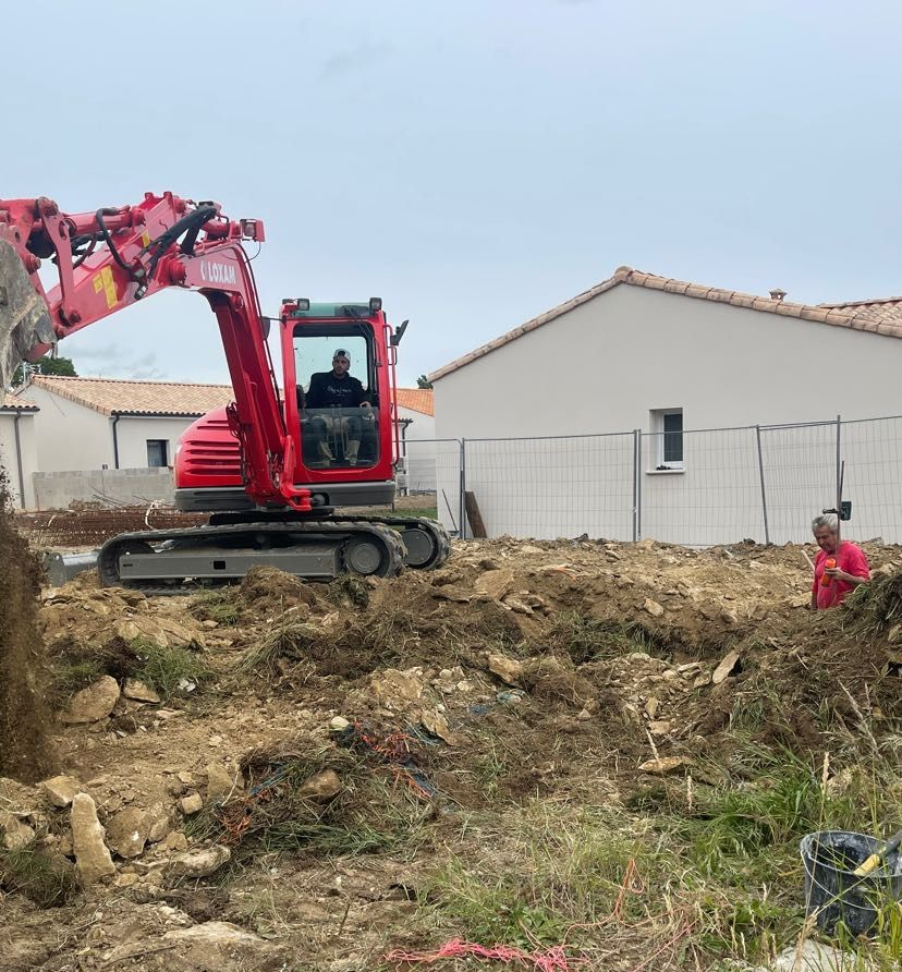 Chantier de construction avec escalier en béton et structure d'escalier en bois soutenue par des poteaux métalliques ; bétonnière en arrière-plan.