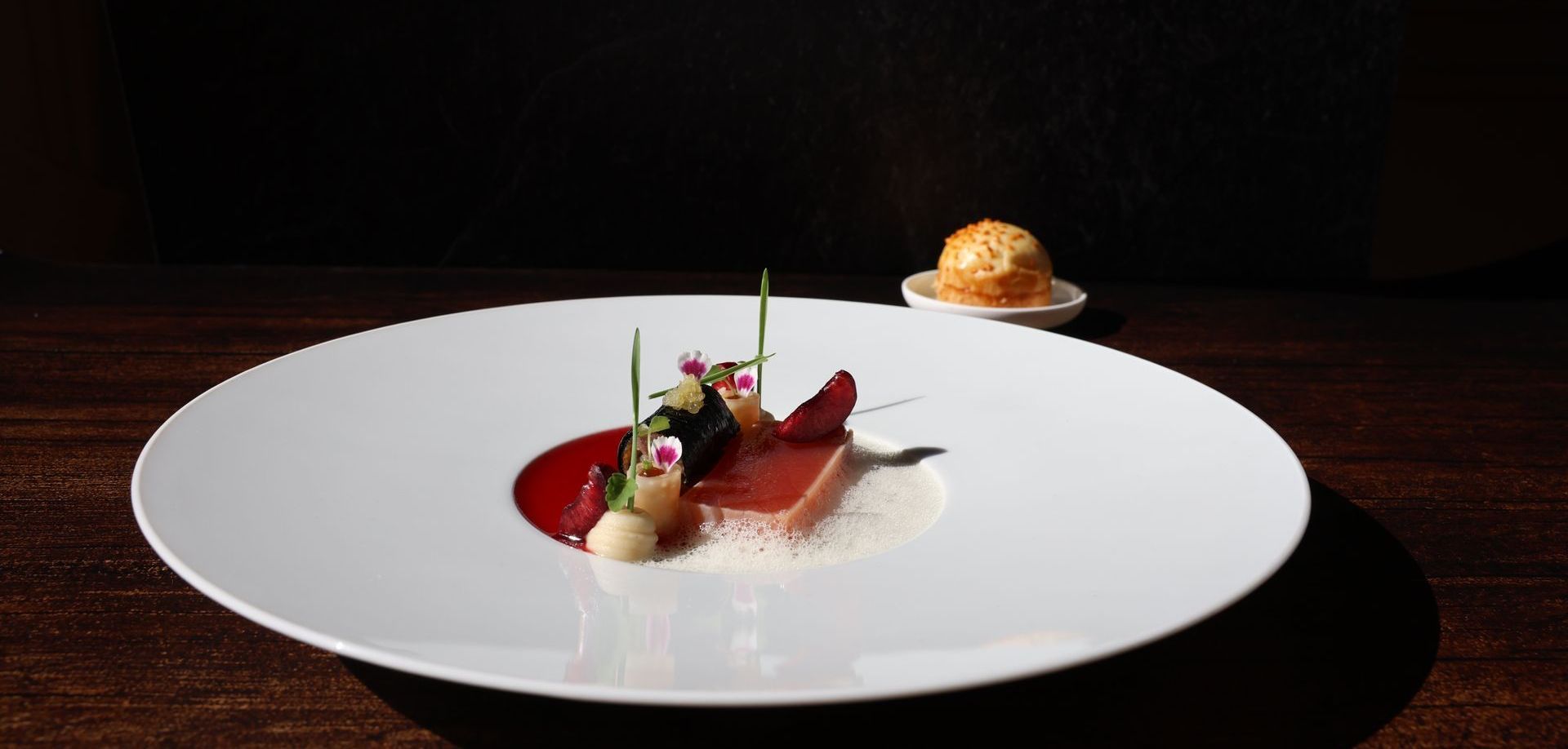 Ein weißer Teller mit einem kleinen Dessert darauf