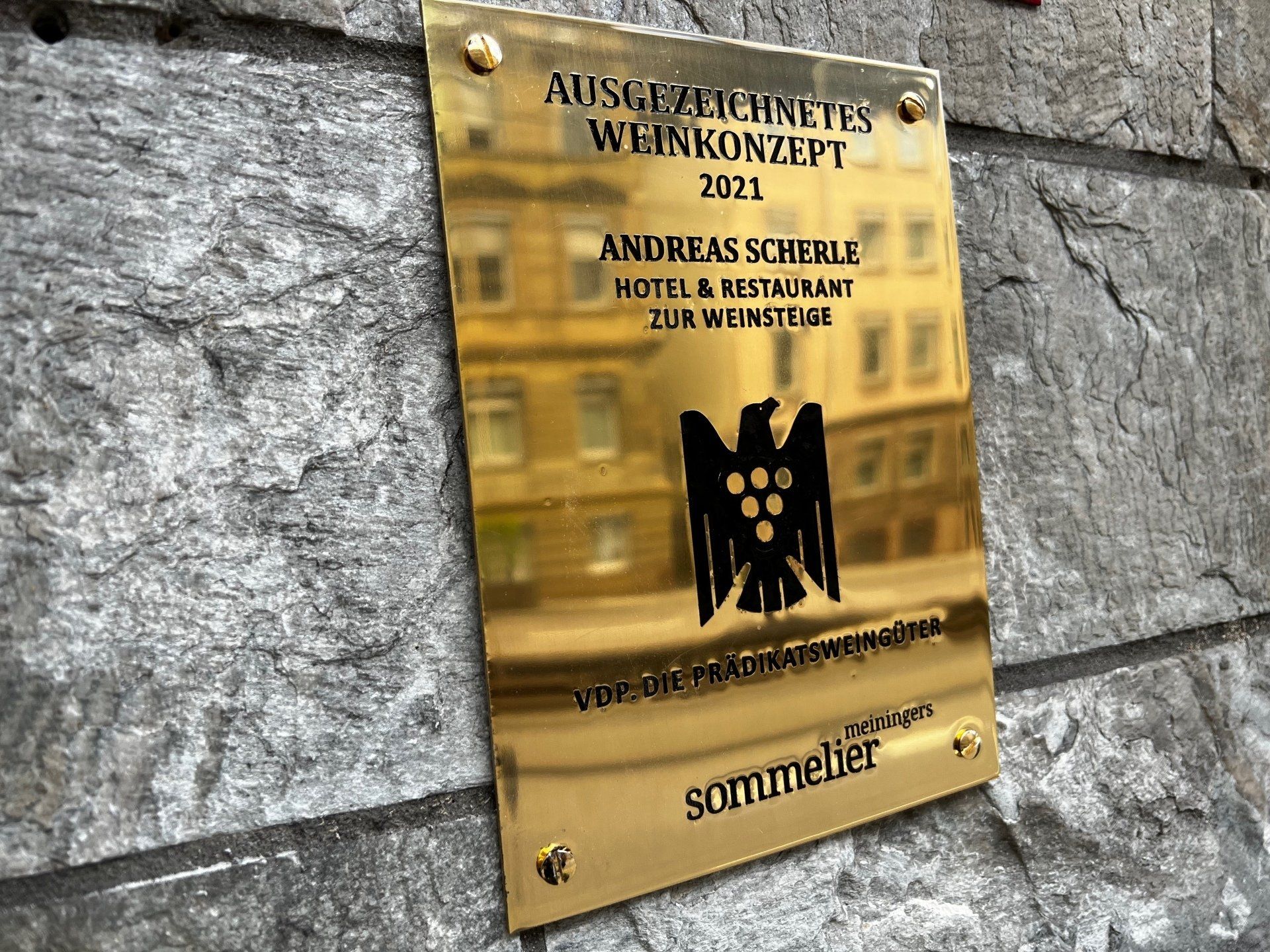 Eine Gedenktafel an einer Wand mit der Aufschrift Andreas Schemer Hotel & Restaurant