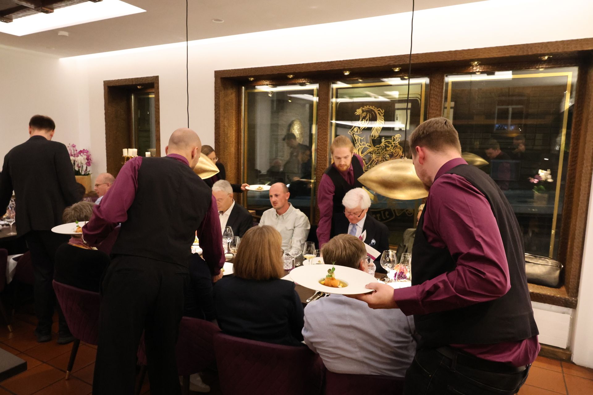 Ein großer Raum mit vielen Leuten, die an Tischen sitzen