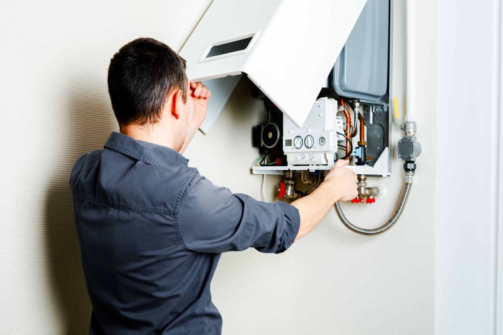Appareil blanc semblable à un distributeur automatique, près d’un mur en briques dans un couloir intérieur étroit