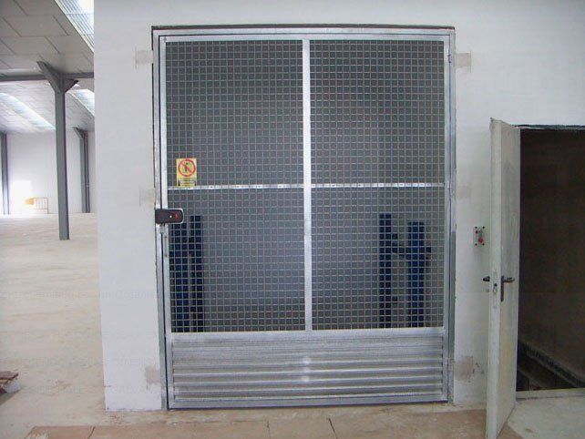 Una jaula con una puerta que está abierta en una habitación