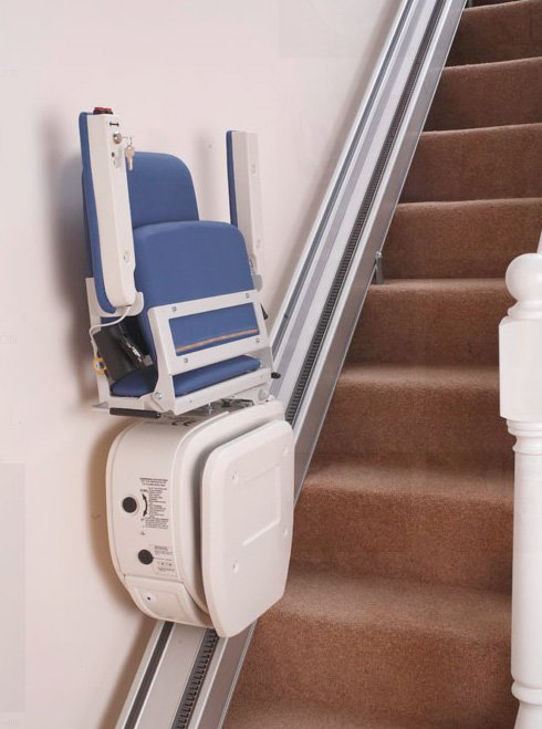 Una silla azul está sentada al costado de unas escaleras.