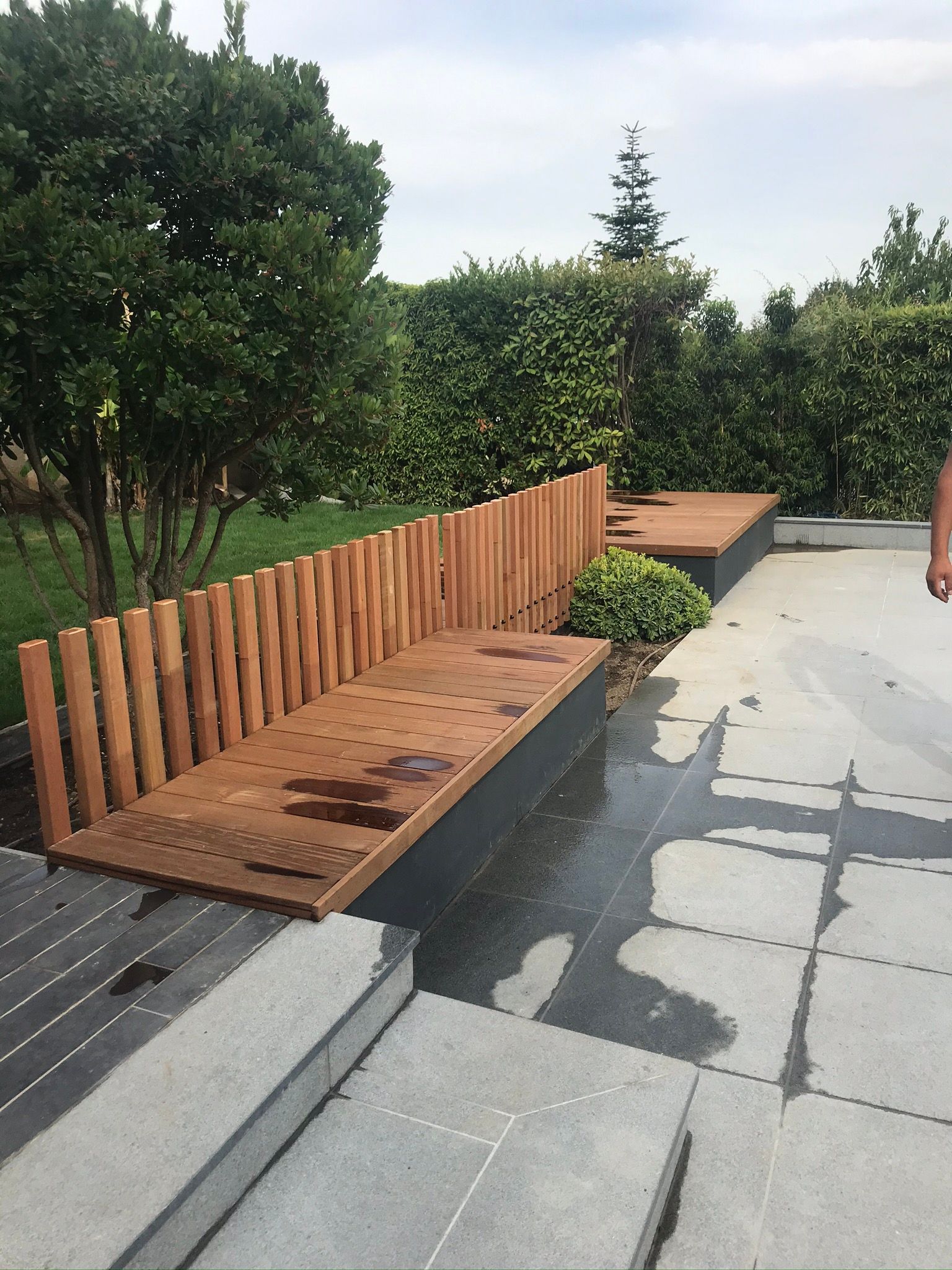 Banc en bois avec clôture dans un espace extérieur aménagé.