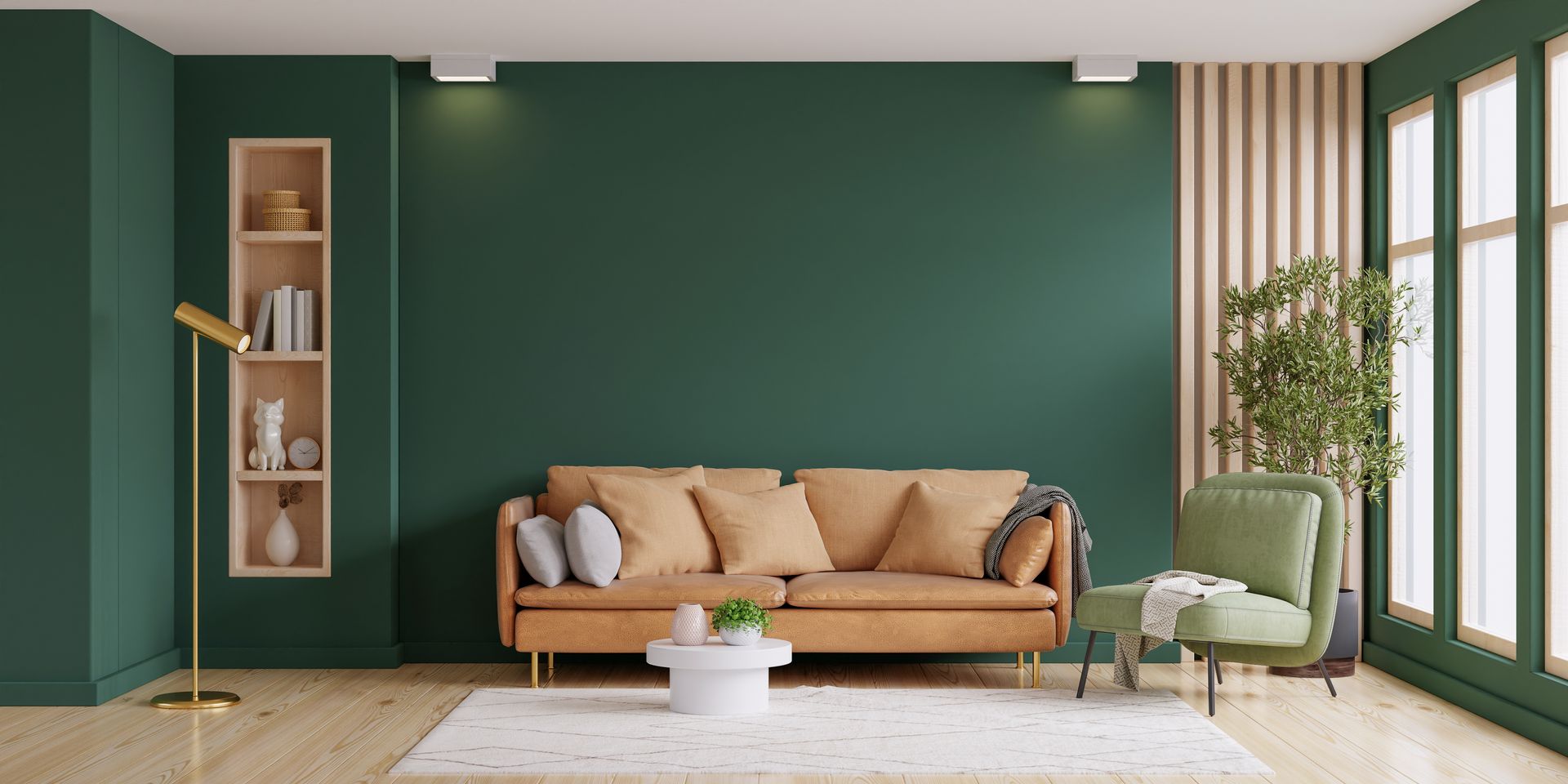 Un mur de couleur vert foncé derrière un canapé.