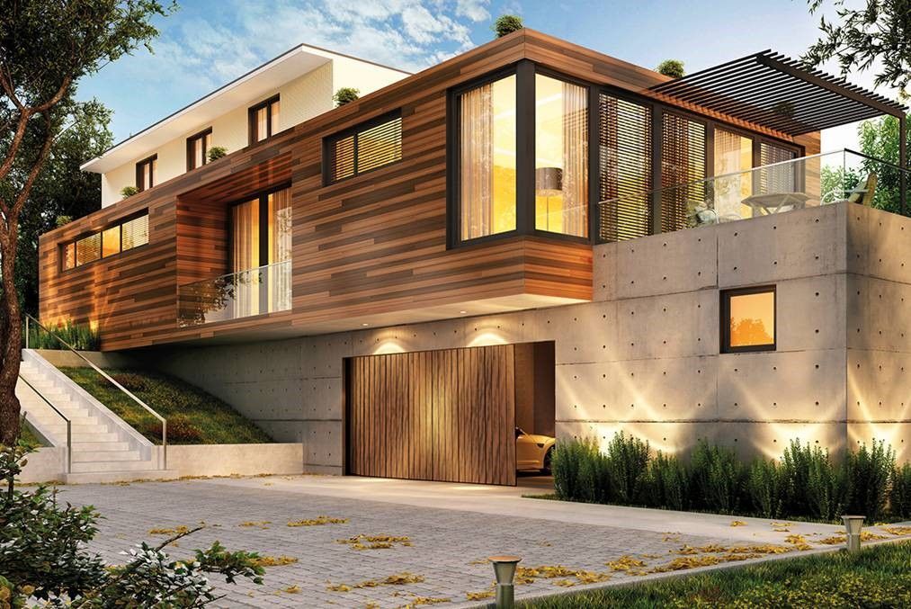 Auf einem Hügel steht ein modernes Haus mit vielen Fenstern.