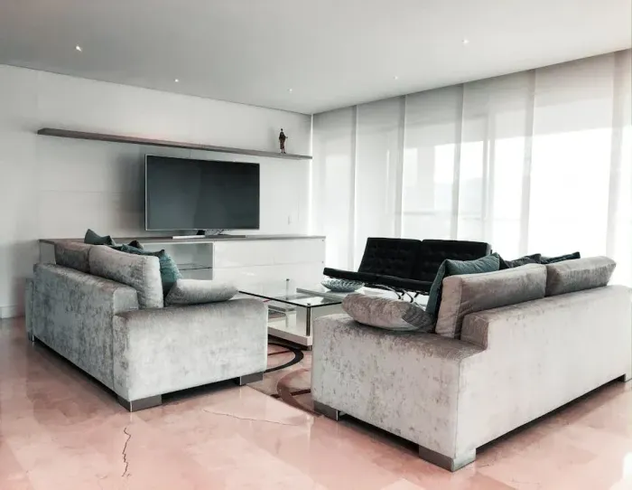Una sala de estar con dos sofás y un televisor de pantalla plana.