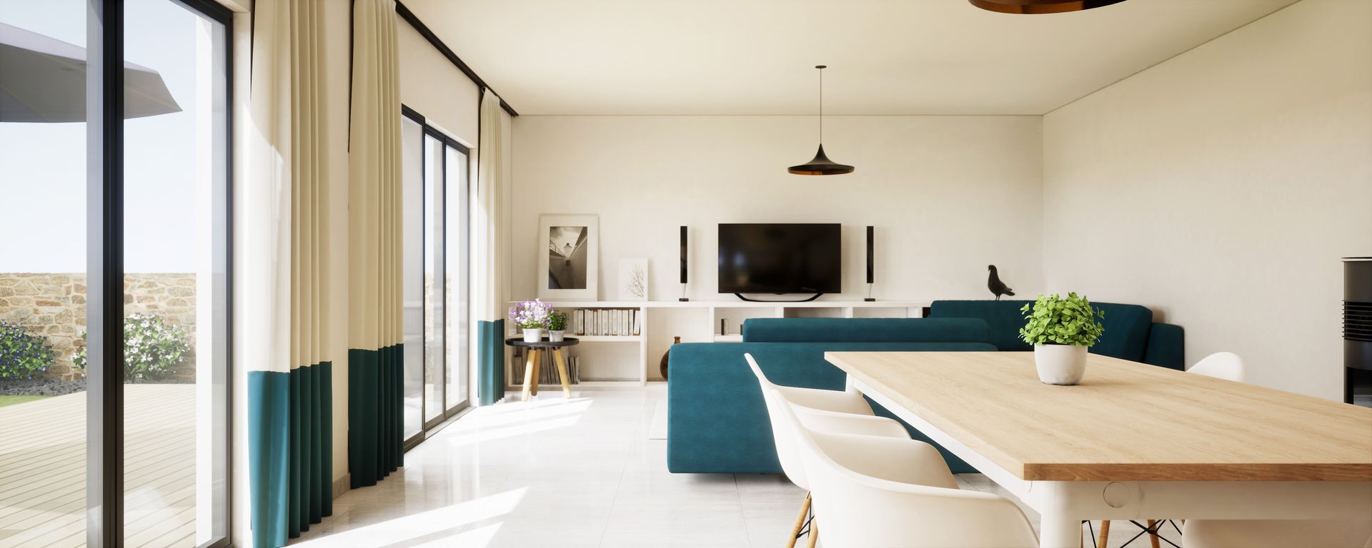 Un salon lumineux avec un canapé bleu canard, une table à manger en bois, des murs blancs et de grandes baies vitrées.