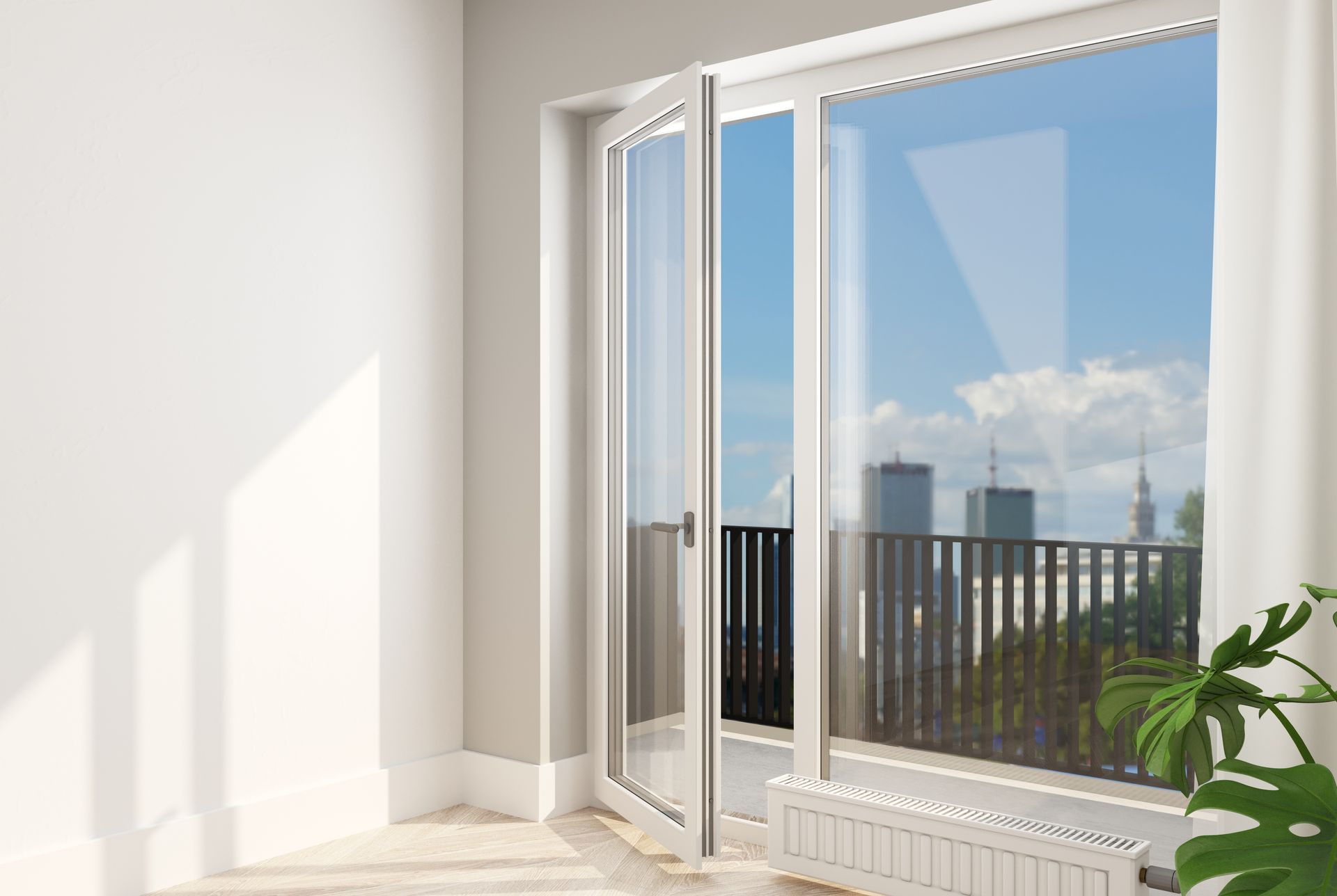 Dans une pièce lumineuse, une porte-fenêtre blanche ouverte sur un balcon.