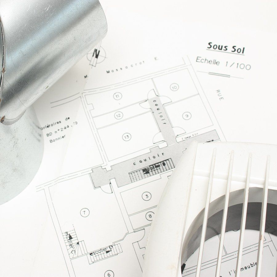 Plan d'une maison avec cache de VMC posé dessus