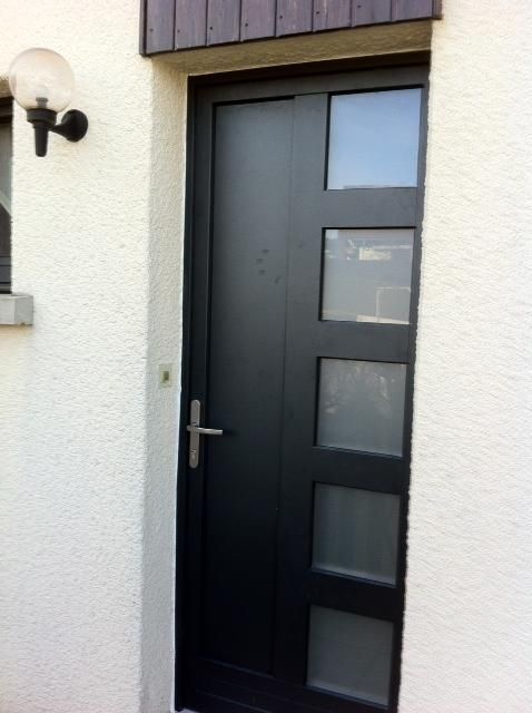 Porte d'entrée en bois avec un double vitrage.