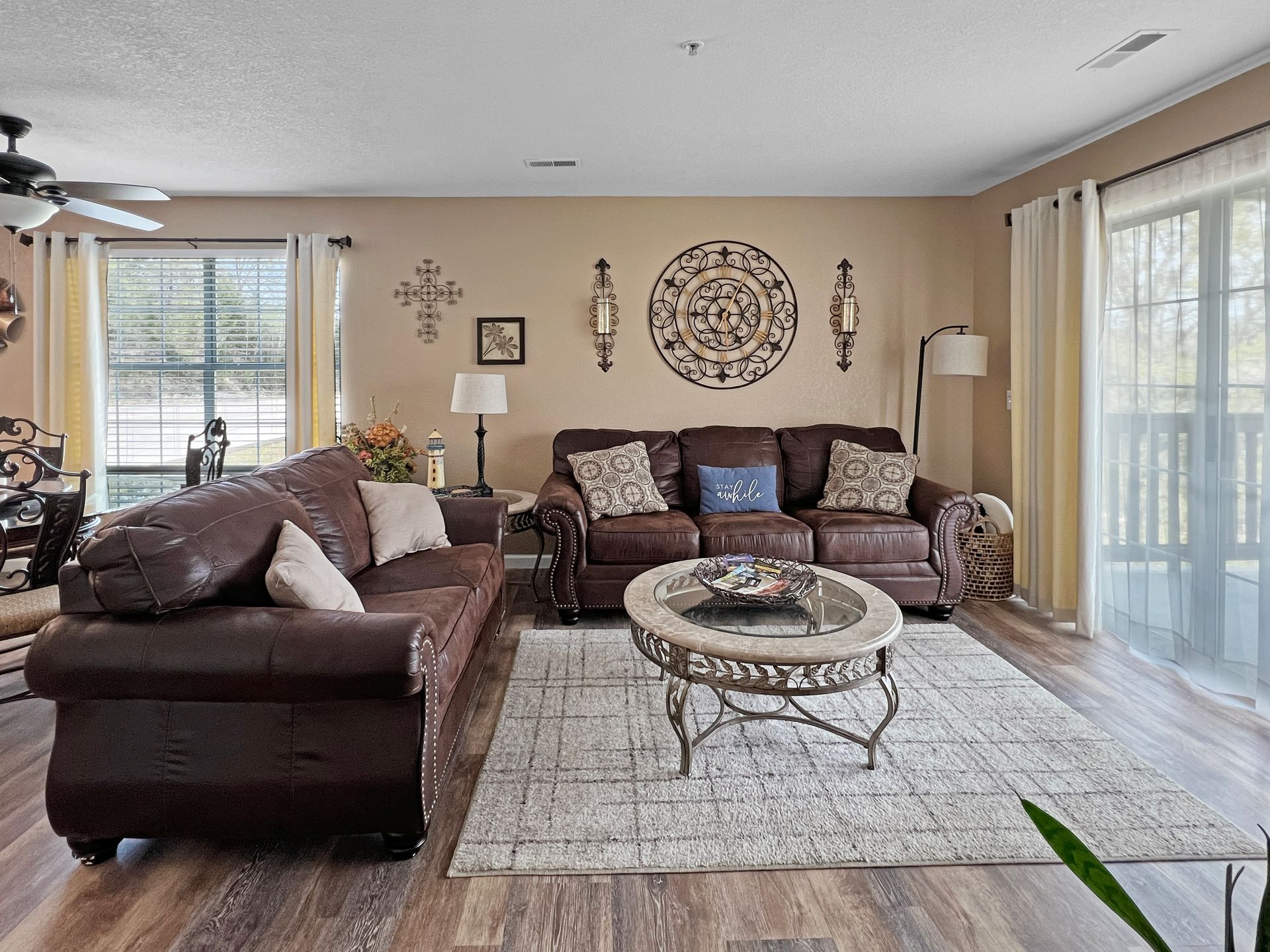 A living room with a couch , coffee table , and sliding glass doors.