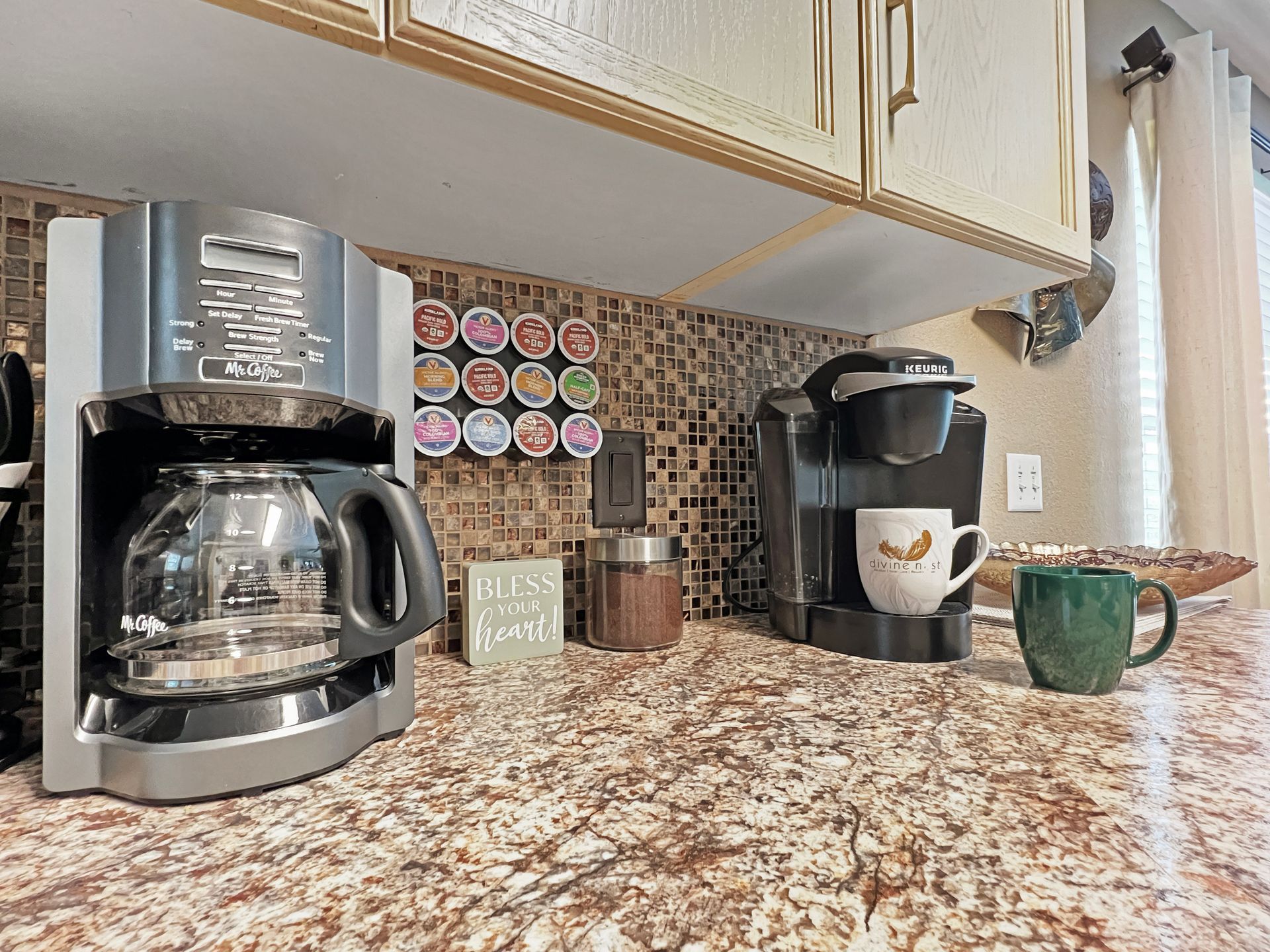 A coffee maker and a keurig coffee maker are on a kitchen counter.