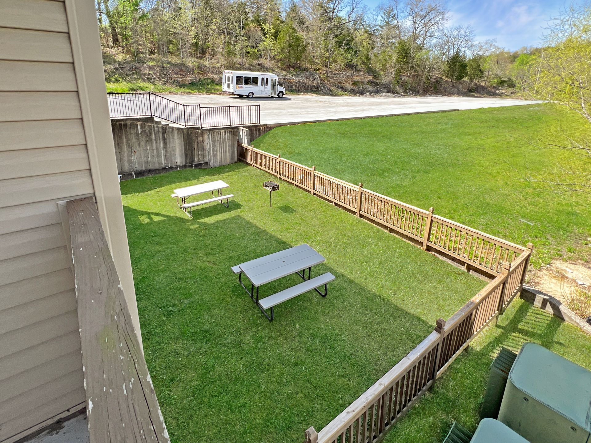 An aerial view of a picnic area with tables and benches in the grass.