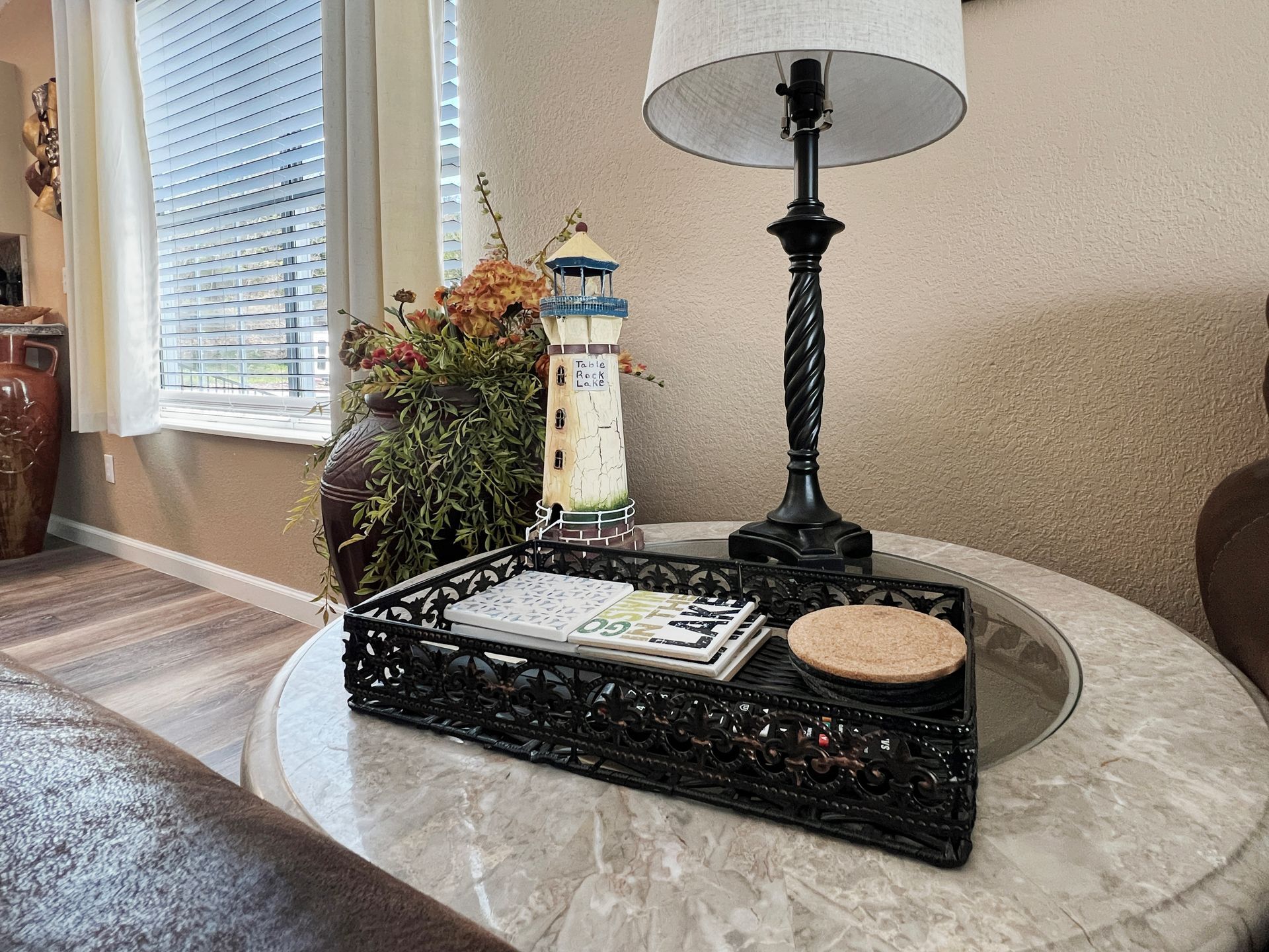 A lamp and a tray are on a table in a living room.