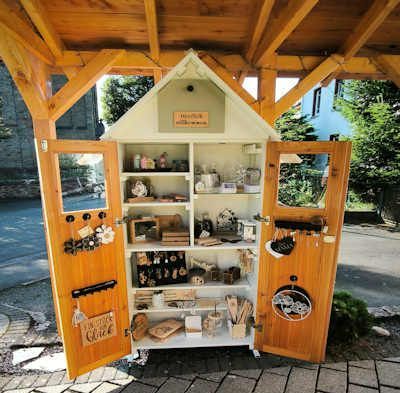 Ein kleiner Schrank in Form eines Hauses mit offenen Türen