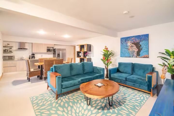 A white house with a large swimming pool in front of it