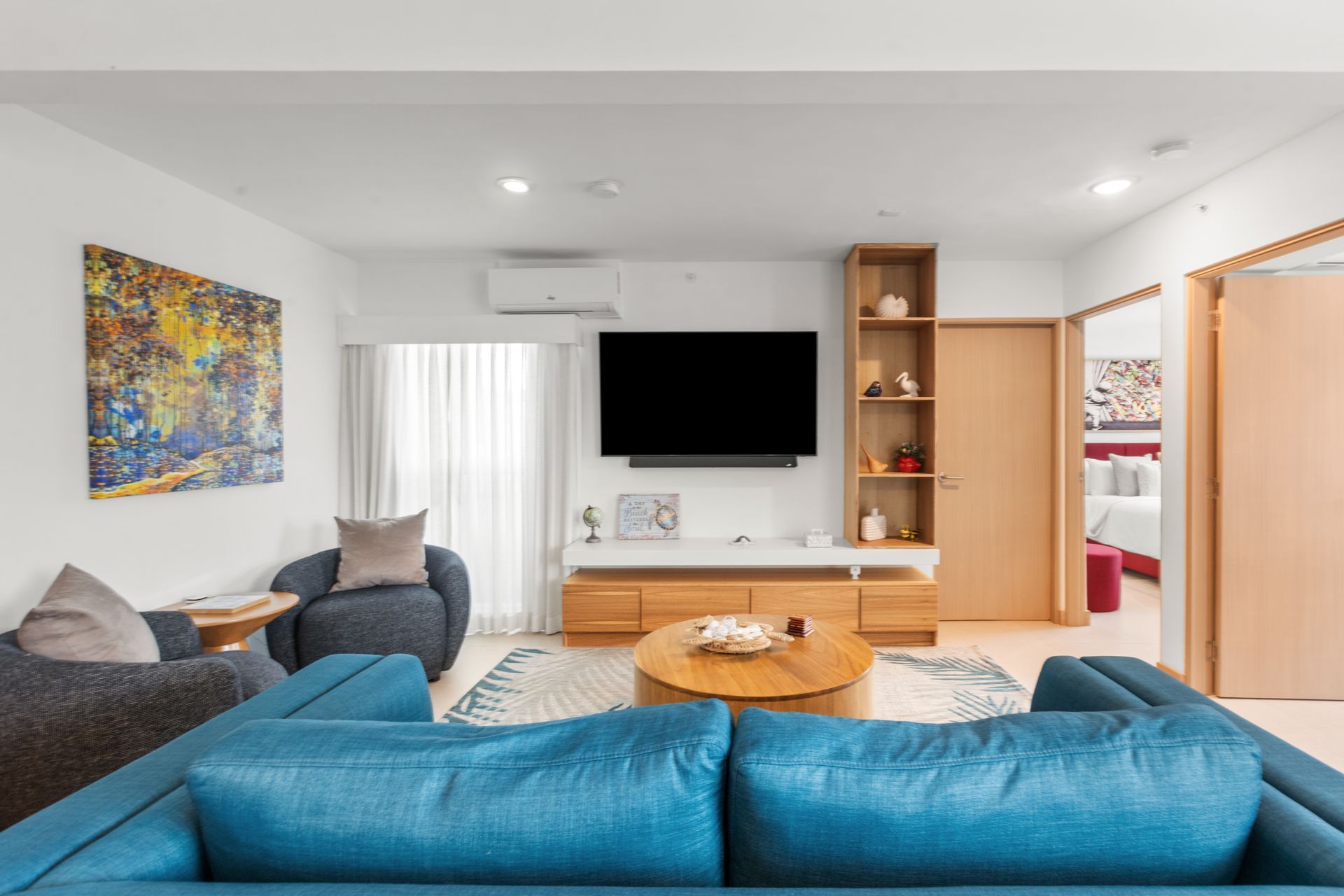 A white house with a large swimming pool in front of it