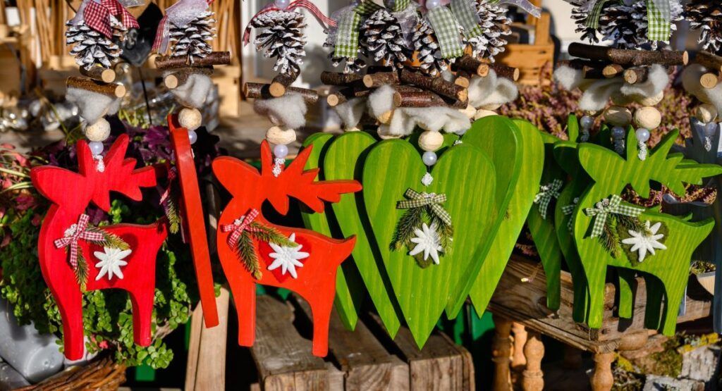 Colorful handmade wooden reindeer ornaments and artisan Christmas decorations at Astoria Oregon holiday market, 25 minutes from Gearhart vacation rentals
