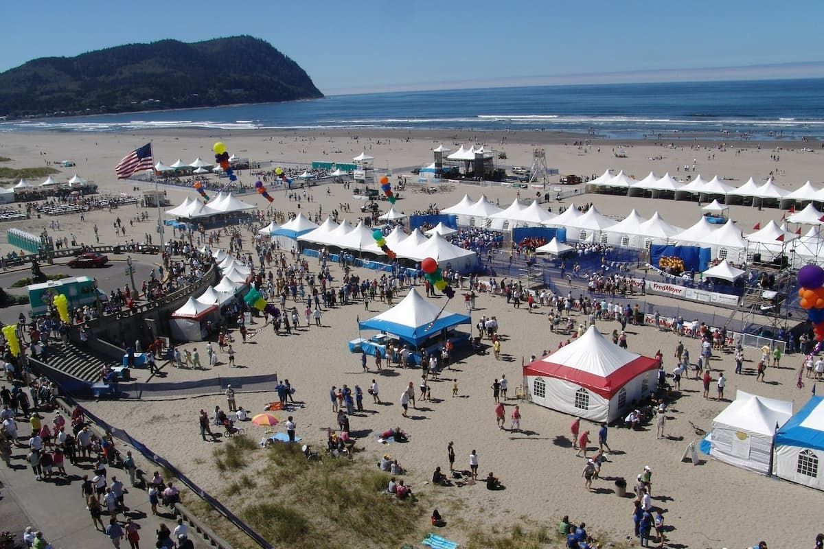 Crowds and event tents at the Hood to Coast relay race finish line on the beach in Seaside, Oregon