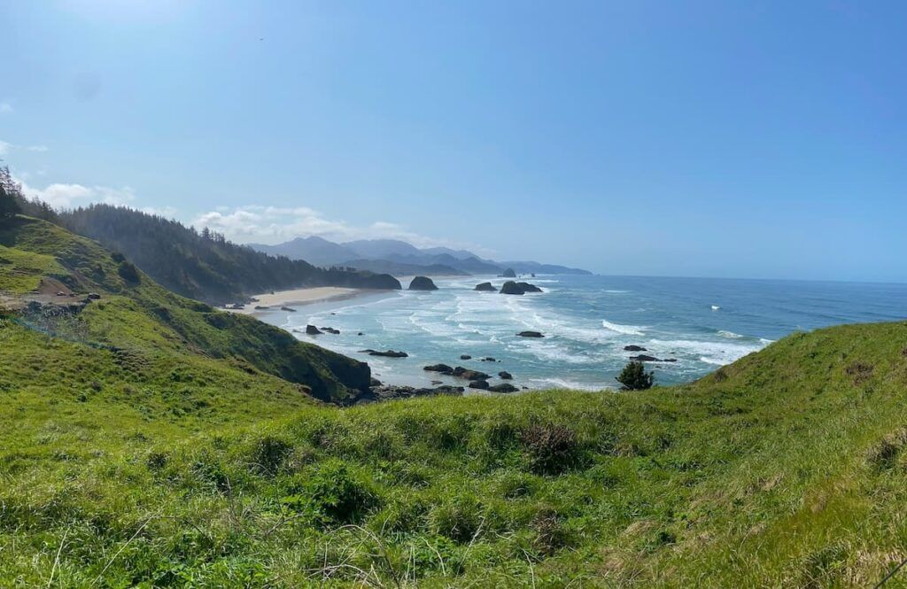 Green hillside overlooking the rocky Pacific coastline at Ecola State Park near Cannon Beach, Oregon