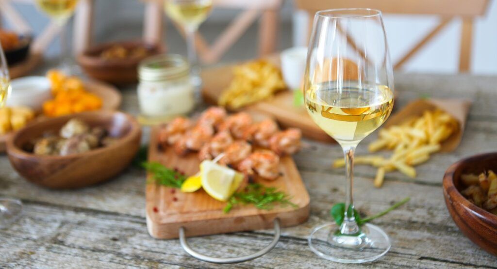 Fresh seafood and wine at a relaxed coastal restaurant near Gearhart Oregon, senior-friendly dining experience on the Oregon Coast