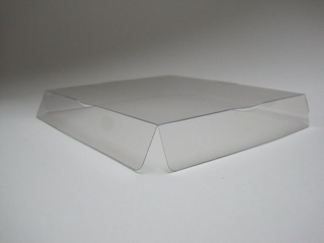 Una caja de plástico transparente está sobre una superficie blanca.