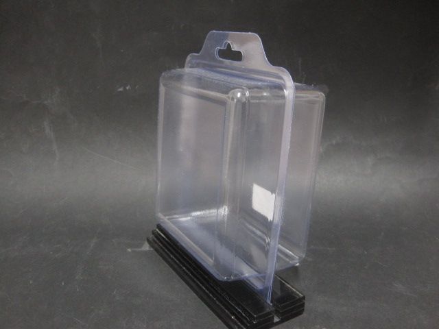 Un recipiente de plástico transparente está colocado encima de una base negra.