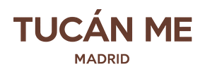 Logotipo con la inscripción “TUCÁN ME” en color marrón y la palabra “MADRID” debajo sobre un fondo blanco.