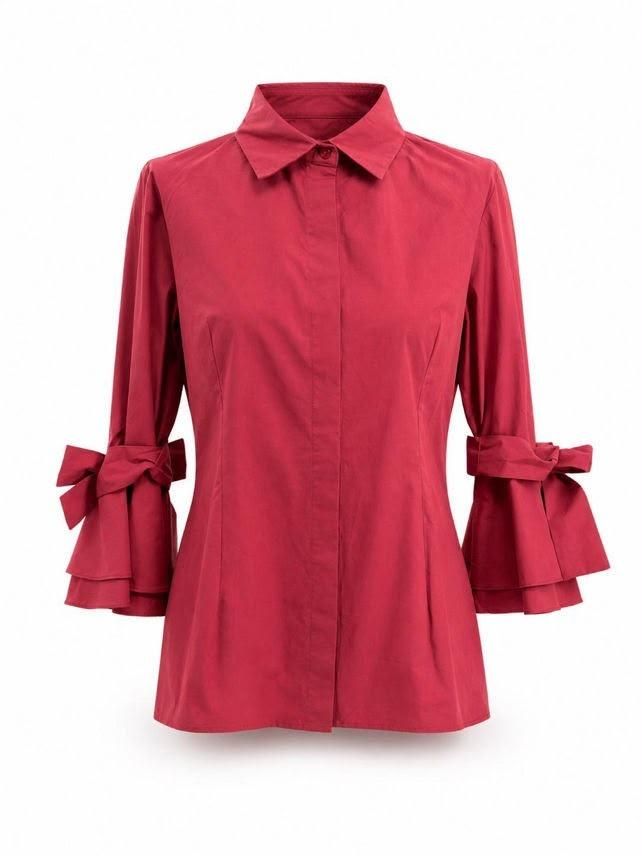 Blusa roja de manga larga abotonada con puños acampanados con volantes y detalles de mangas anudadas.