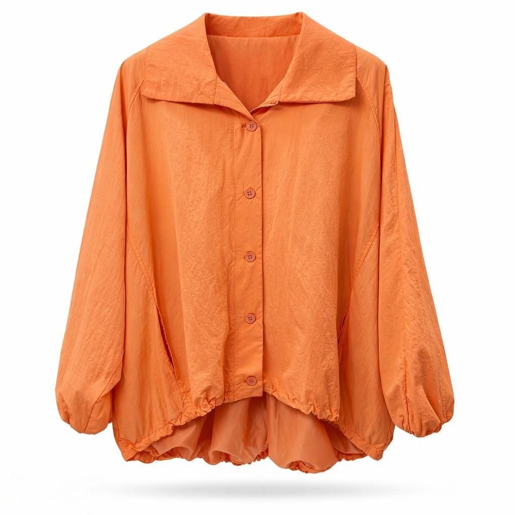 Blusa naranja extragrande abotonada con mangas largas y bajo suelto y drapeado.